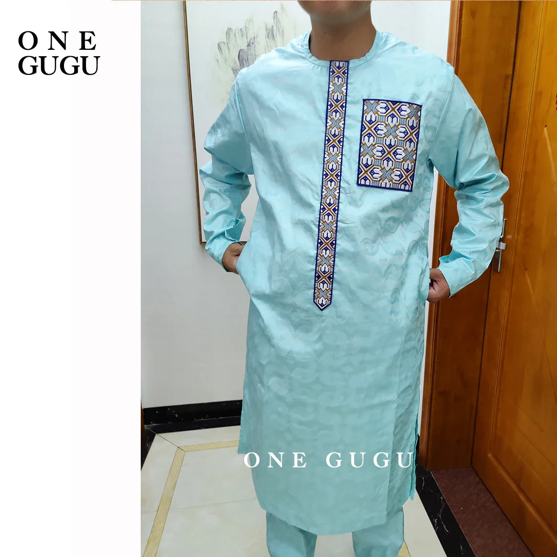 Detailed close-up of the traditional Nigerian Dashiki shirt in luxurious blue, showcasing intricate jacquard design and hand-crafted weaving.