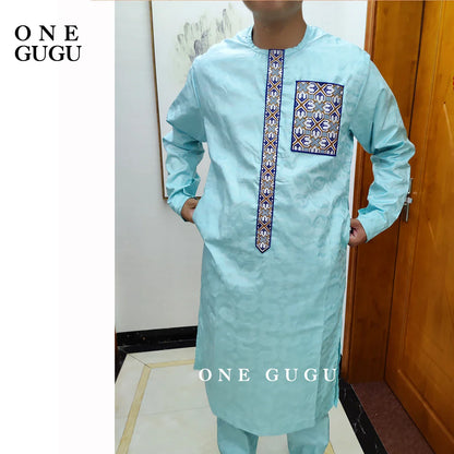 Detailed close-up of the traditional Nigerian Dashiki shirt in luxurious blue, showcasing intricate jacquard design and hand-crafted weaving.