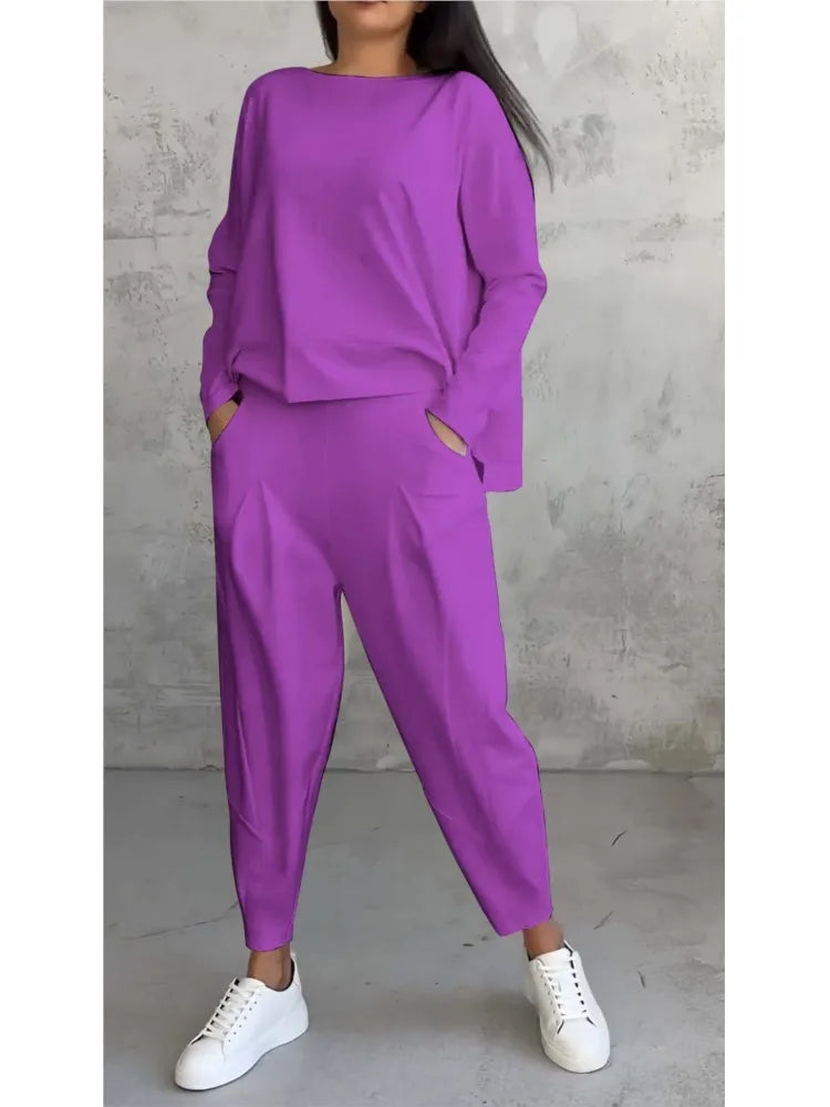 Elegantly styled women’s casual loose sports set featuring long sleeve irregular top and high waist harem pants, perfect for autumn and winter fashion.