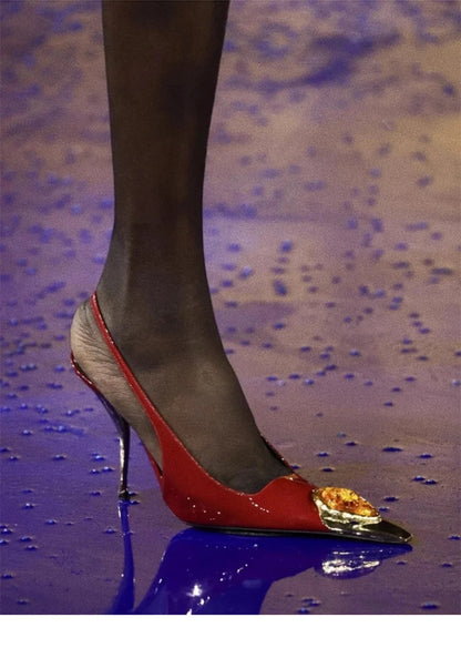 Close-up of luxurious red high heel sandals with exquisite fox head jewel detailing, designed for women's fashion.