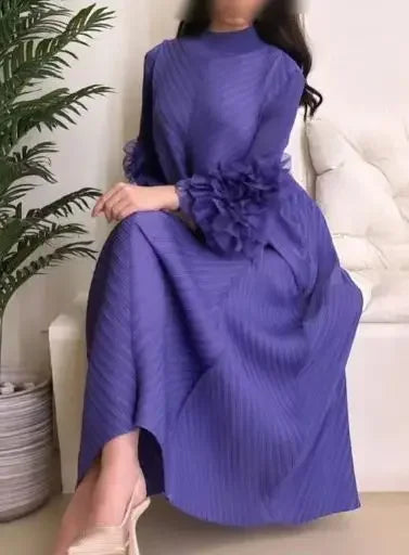 Model wearing the chic pleated Maxi Dress with petal sleeves and half turtleneck, styled for a formal event, exemplifying timeless fashion and elegance for women.