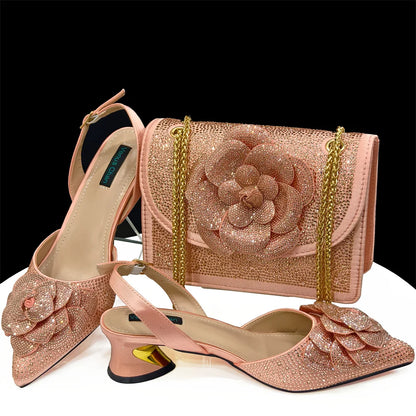 Fashionable women's pump with delicate spike heels and a beautiful floral motif, paired with an elegant handbag for an upscale look.