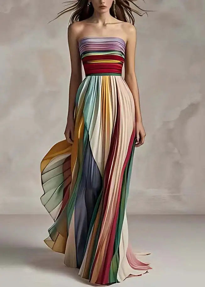 Sophisticated woman wearing a colourful striped sleeveless asymmetrical maxi dress, styled for a summer event.