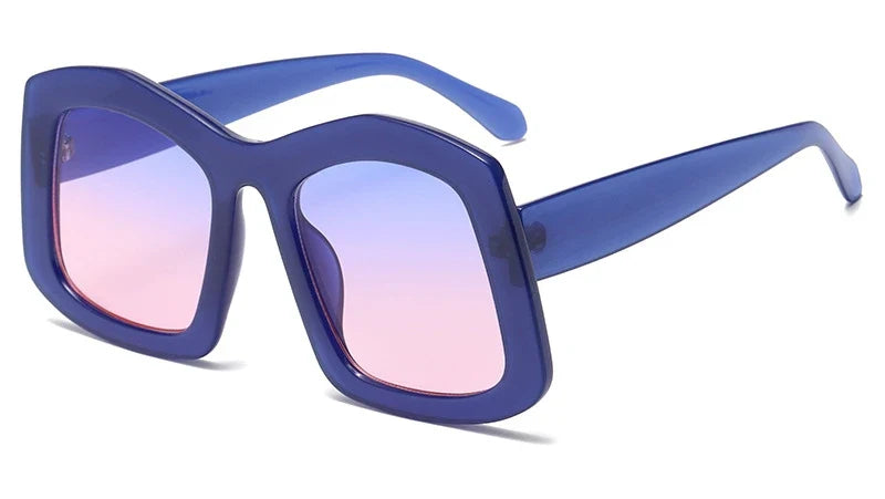 Close-up of luxury women's oversized square sunglasses featuring a vibrant orange gradient lens and durable polycarbonate construction.