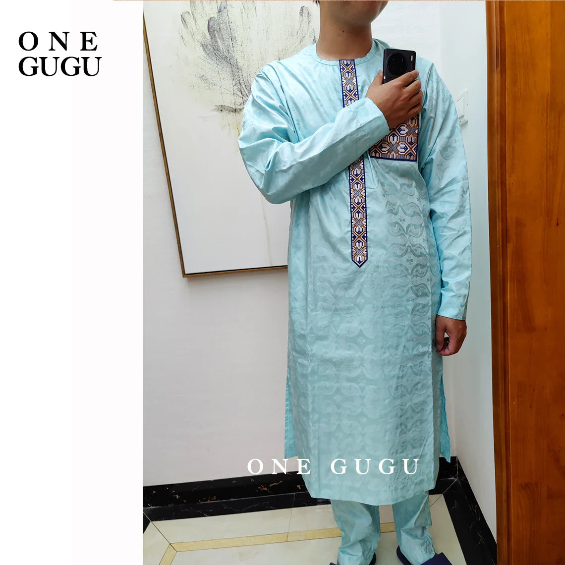 Man wearing premium waterproof African 2-piece set, featuring a distinguished blue cotton shirt and pants, exemplifying traditional Nigerian Dashiki elegance.