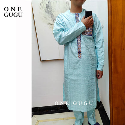 Man wearing premium waterproof African 2-piece set, featuring a distinguished blue cotton shirt and pants, exemplifying traditional Nigerian Dashiki elegance.