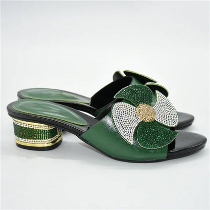 Stylish slip-on sandals for women featuring a sophisticated mid-heel and rhinestone embellishments, available in various chic colours for an elevated look.