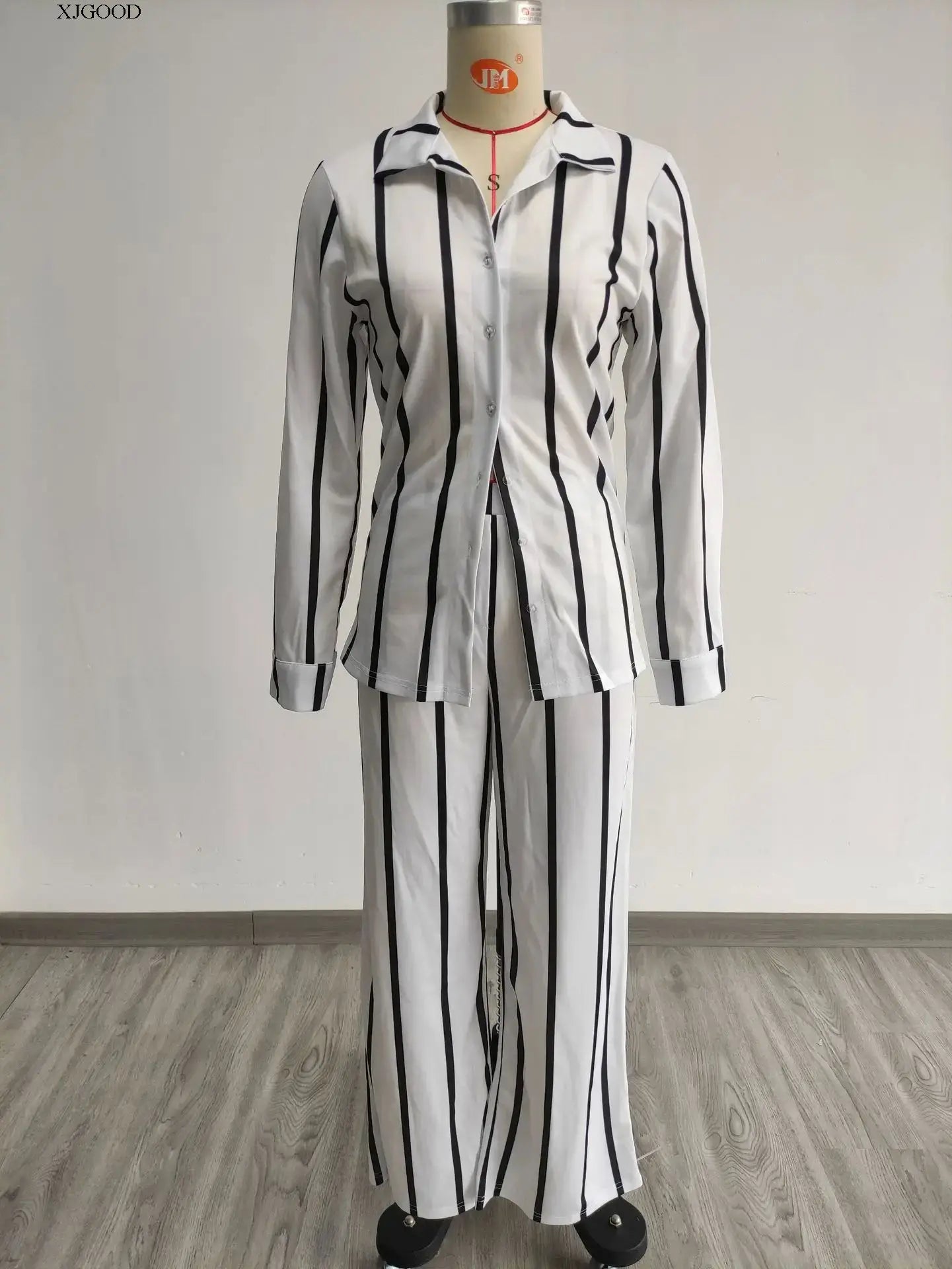 Close-up view of the luxurious fabric and intricate details of the women's striped long pants from the casual two-piece set.