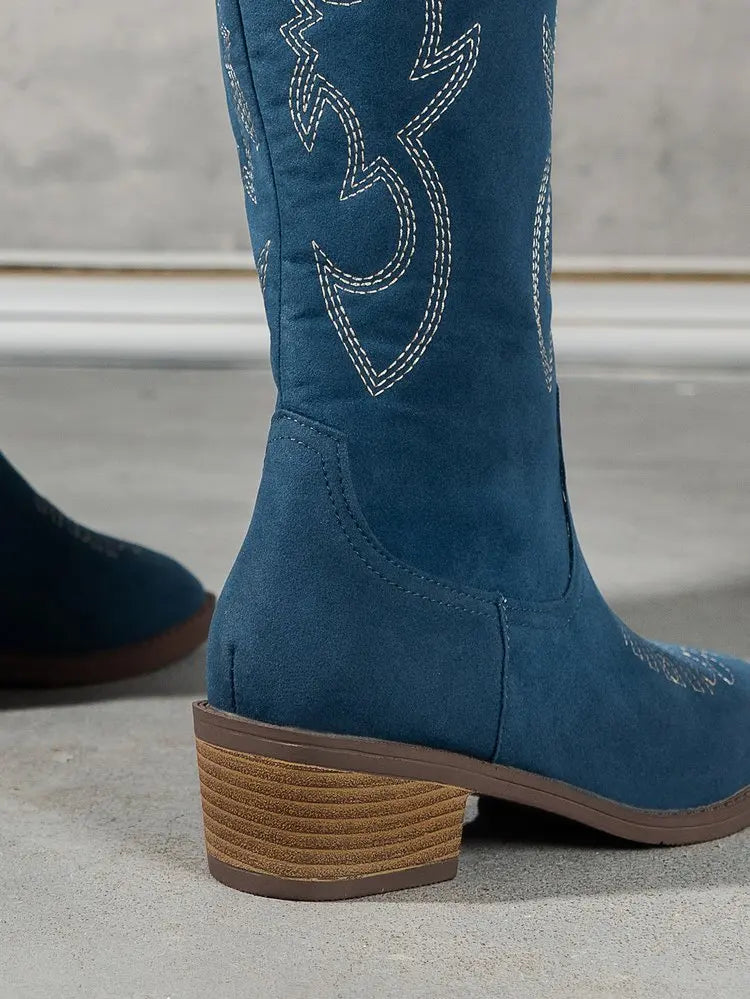 Elegant women's Chelsea cowboy knee-high boots featuring a distinctive zipper closure and mid heels, designed for a punk fashion statement.