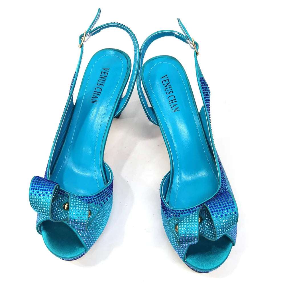 Sleek Metal Handle Clutch Bag from Venus Chan, elegantly matched with high heels, perfect for formal events and special occasions.