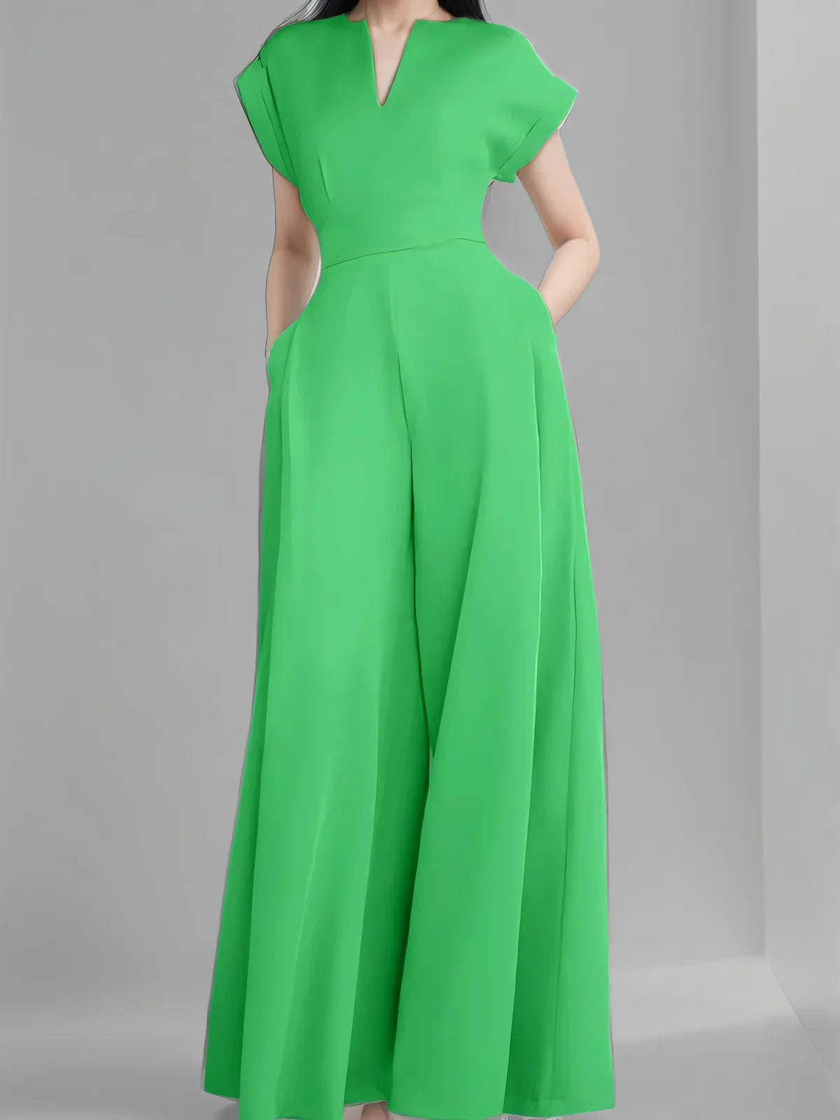 Chic women's wide leg jumpsuit worn by model in elegant outdoor setting, perfect for spring and summer occasions.