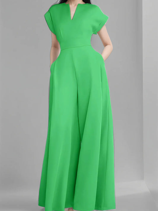 Chic women's wide leg jumpsuit worn by model in elegant outdoor setting, perfect for spring and summer occasions.