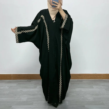 Luxurious golden velvet Moroccan Dubai dress featuring elegant bat sleeves and intricate sequin embellishments, perfect for sophisticated Muslim fashion.