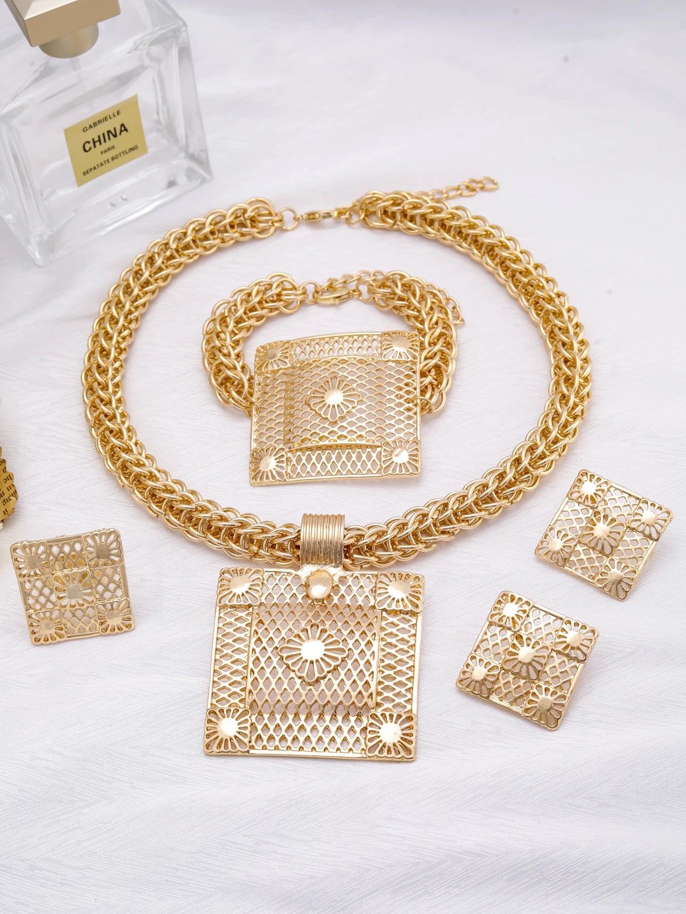 Stylish earrings from the Luxury Geometric 18K Gold Plated Jewelry Set, ideal for formal occasions and enhancing women's elegance.