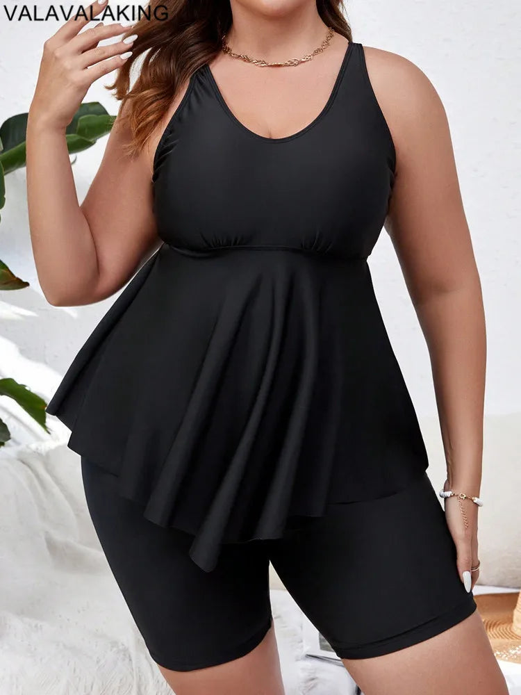 Chic model wearing Valavalaki Plus Size Tankini Set on a beach, radiating confidence with flattering large swimwear, ideal for summer getaways.