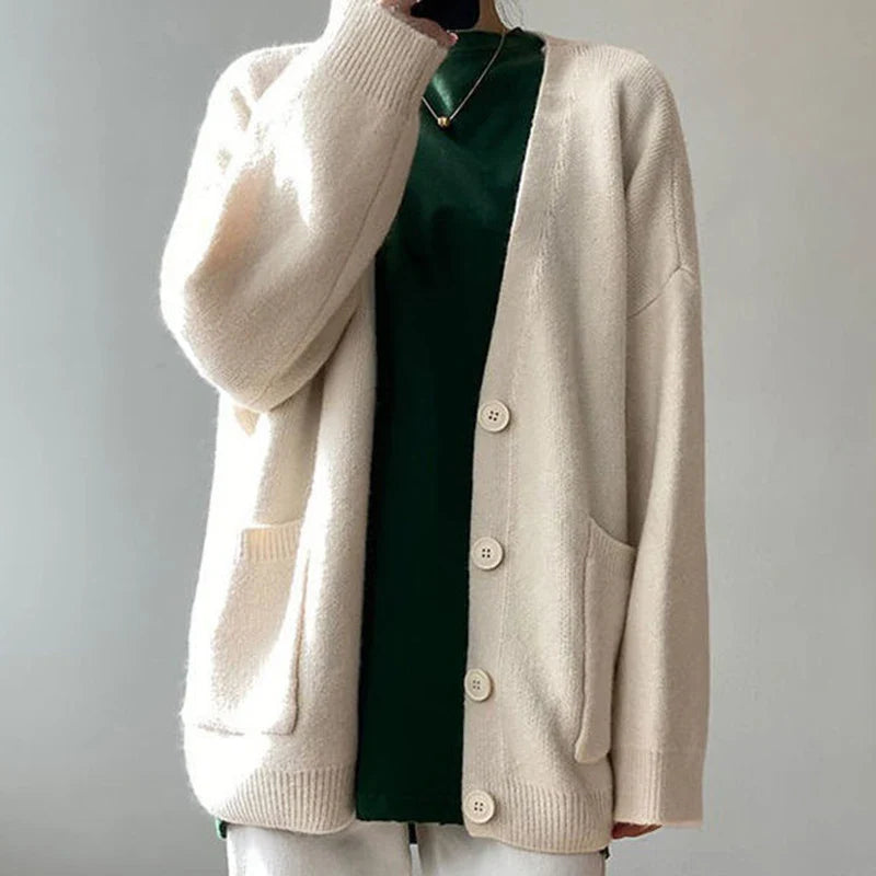 Exquisite Rimocy knitted cardigan for women, featuring a classic V-neck and button detailing, designed for a chic and minimalist aesthetic.