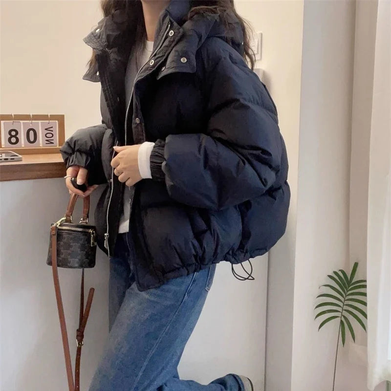 Elegant woman's slim fit hooded puffer jacket, expertly crafted in cotton and polyester, perfect for stylish winter wear.