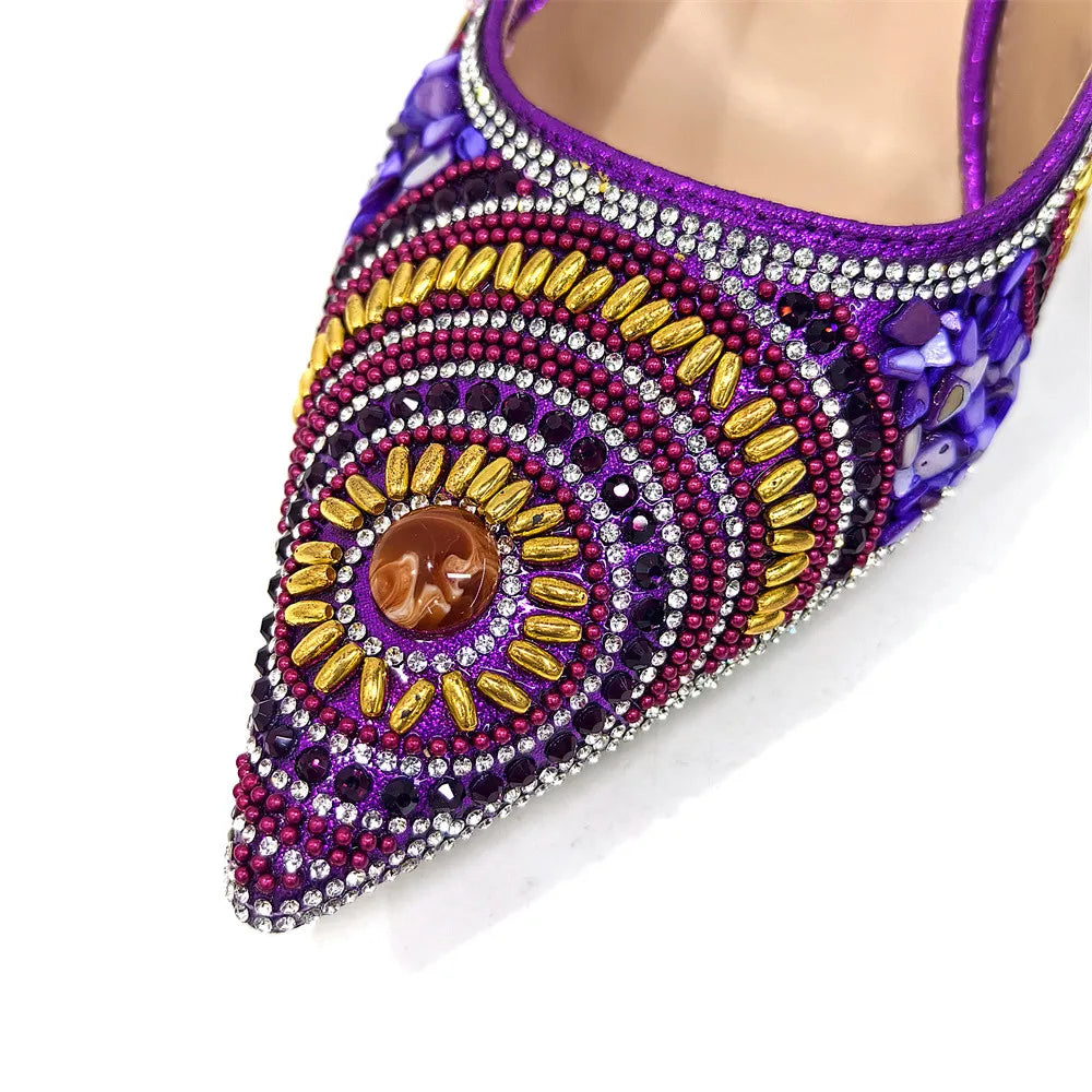 Sophisticated handbag with a long chain shoulder strap, beautifully paired with blue pointed toe pumps, perfect for a luxurious evening out.