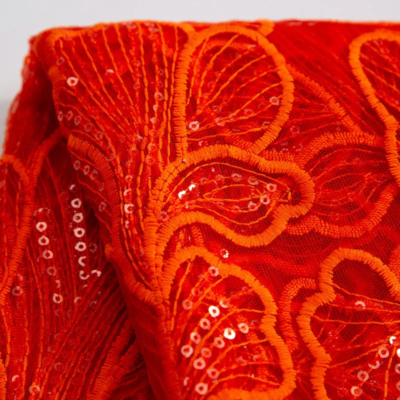 Stylish African-inspired mesh lace fabric with soft drapery, ideal for sophisticated wedding dress designs, reflecting elegance with every stitch.