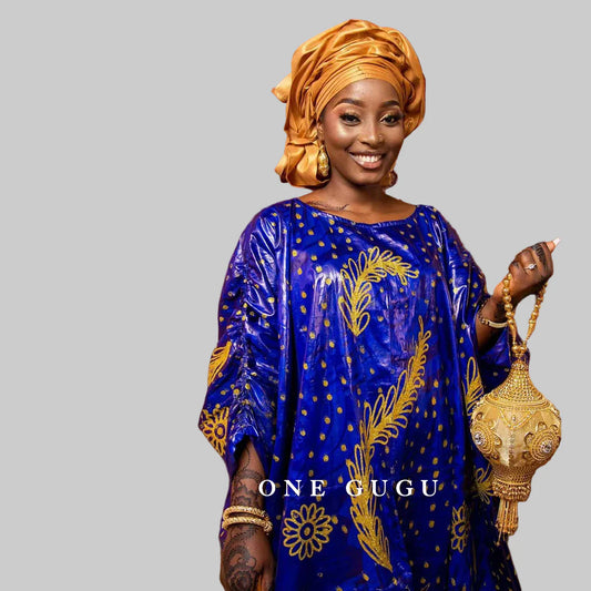 Elegant blue Bazin Riche boubou dress showcasing intricate traditional embroidery details, designed for women seeking luxury in African fashion.