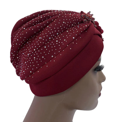 Elegant African turban cap adorned with rhinestone accents, showcasing exquisite craftsmanship, perfect for stylish women seeking a luxurious head wrap.