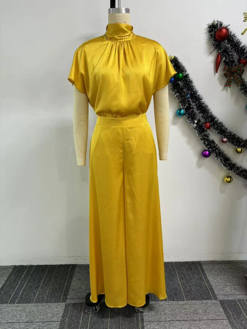 High waist wide leg pants in a rich satin fabric, tailored for a flattering fit, perfect for a stylish ensemble.