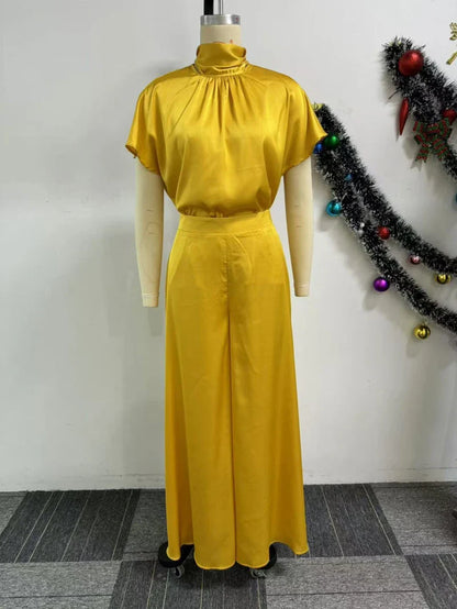 High waist wide leg pants in a rich satin fabric, tailored for a flattering fit, perfect for a stylish ensemble.