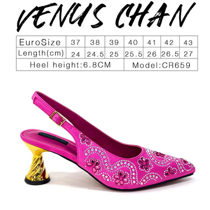 Chic fuchsia handbag with metal handle and long chain shoulder strap, perfectly paired with matching high heel pumps for a sophisticated look.