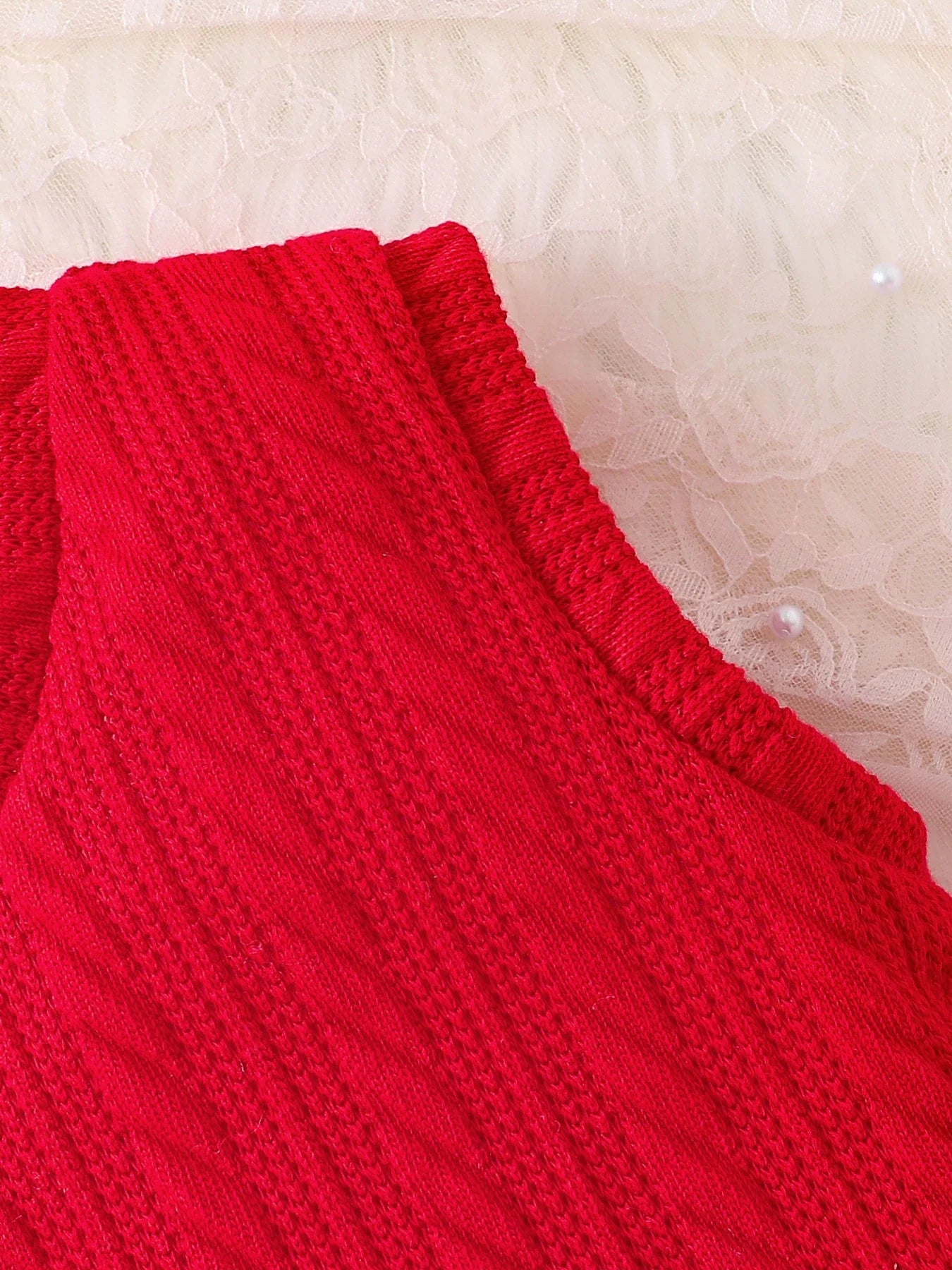 Chic close-up of a luxury red tank top with lace collar from a 3-piece knitted set for girls aged 4-6, designed for elegant autumn wear.