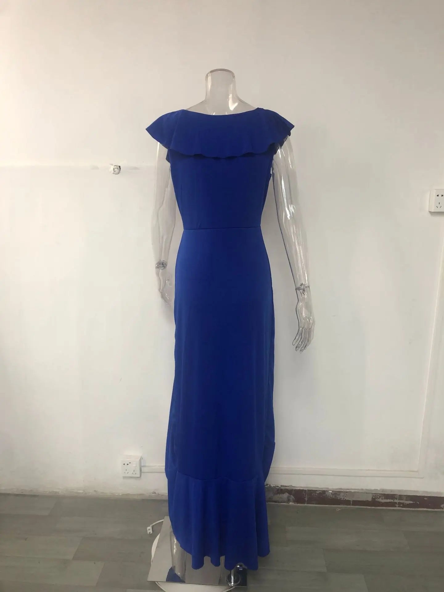 Woman wearing the Elegant V Neck Ruffles Maxi Dress in a scenic outdoor setting, showcasing its flattering slim fit and graceful drape.