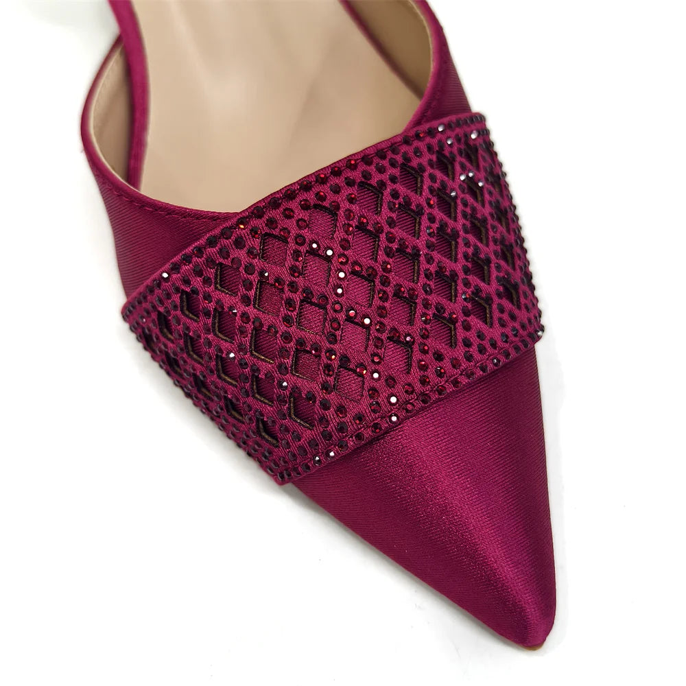 Elegant Nigerian women's wine colour heeled shoes adorned with rhinestones, perfect for parties and weddings, featuring a pointed toe and spike heels.