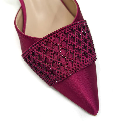Elegant Nigerian women's wine colour heeled shoes adorned with rhinestones, perfect for parties and weddings, featuring a pointed toe and spike heels.