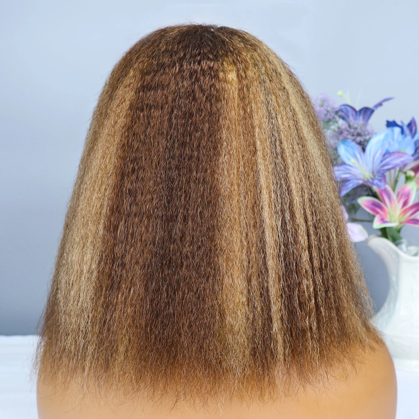 High-quality 13x4 Human Hair Lace Frontal Wig in Kinky Straight texture, showcasing a short brown bob with stunning blonde highlights.