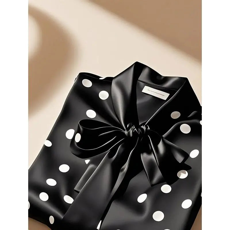 Sophisticated women's blouse in satin with a stylish bow embellishment, designed for a refined and classy office atmosphere.