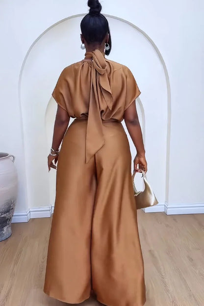 Stylish African-inspired outfit set featuring matching satin lace-up top and high waist wide leg pants for a chic look.