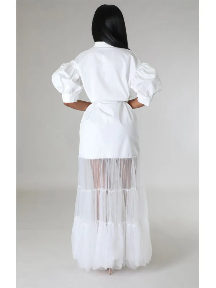 Model wearing a chic white lace shirt dress with short sleeves and a turn-down collar, exuding elegance in a spring/summer setting.