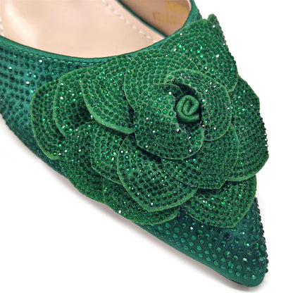 Luxury women's shoe and bag ensemble showcasing sleek pointed-toe pumps and a matching handbag adorned with sparkling rhinestones, designed for formal gatherings.