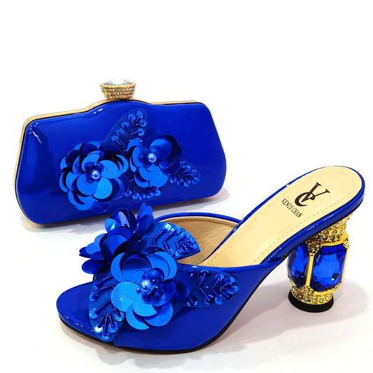 Luxurious royal blue women’s pumps and clutch bag set adorned with rhinestones, perfect for elegant parties and special occasions.