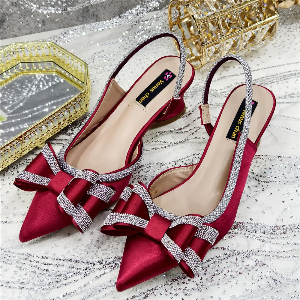 Sophisticated women's peep toe pumps with a high heel, adorned with crystal chains, perfect for glamorous occasions.