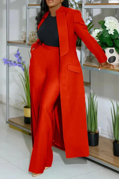 Rear view of a fashionable x-long blazer coat with pockets, tailored for a flattering straight fit, complemented by sleek wide leg trousers.