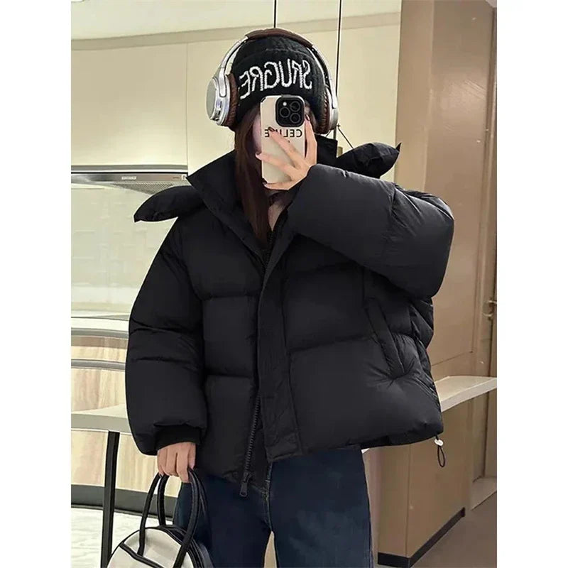 Close-up of high-quality cotton and polyester fabric of a stylish hooded winter coat for women, showcasing its solid pattern and exquisite detailing.