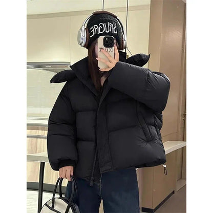 Close-up of high-quality cotton and polyester fabric of a stylish hooded winter coat for women, showcasing its solid pattern and exquisite detailing.