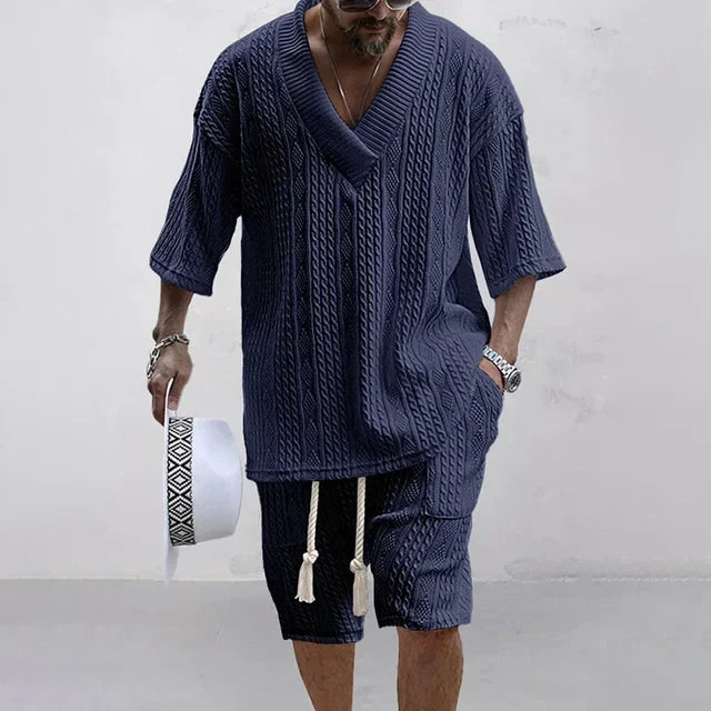 Elegant men's knitted casual summer outfit featuring a stylish V-neck t-shirt paired with drawstring shorts, designed for ultimate comfort and sophistication in solid colour with functional pockets.