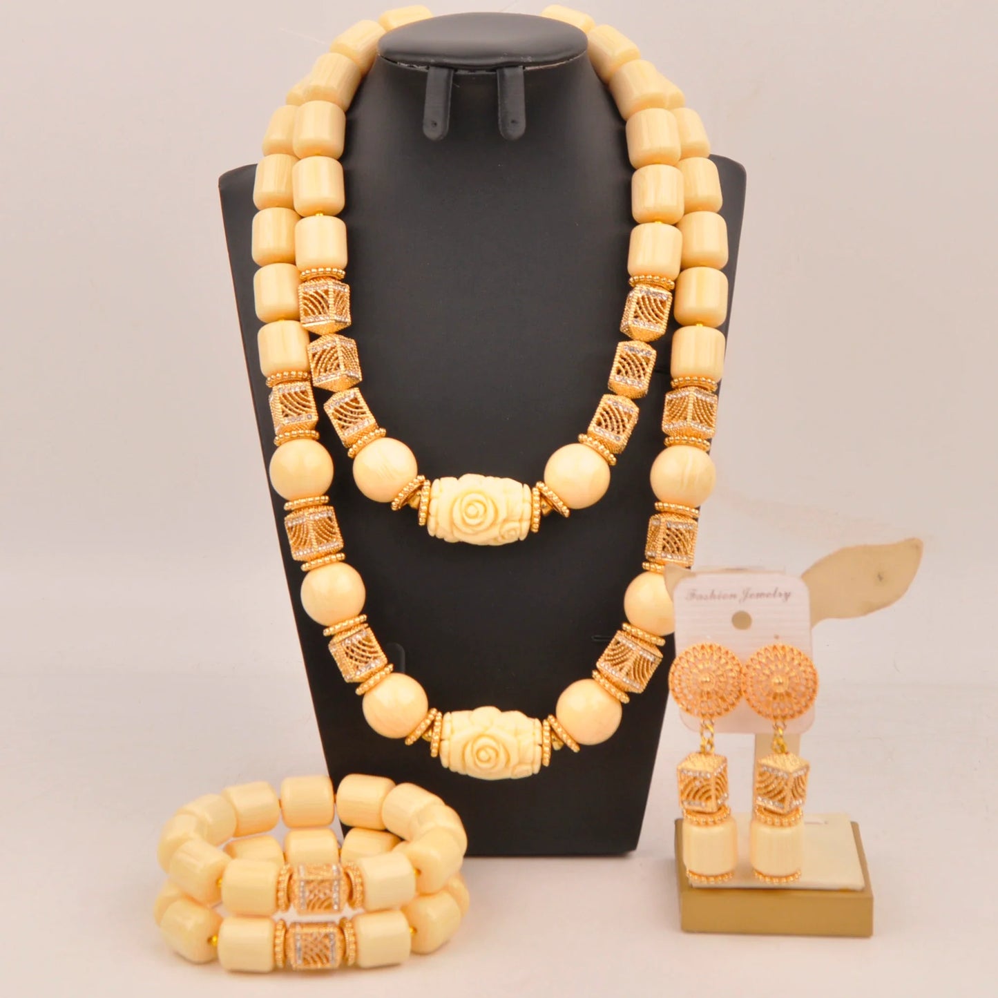 Elegant Nigerian bridal jewelry set showcasing vibrant artificial coral beads, including a necklace, bracelet, and earrings for luxurious wedding adornment.