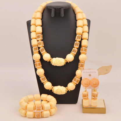 Elegant Nigerian bridal jewelry set showcasing vibrant artificial coral beads, including a necklace, bracelet, and earrings for luxurious wedding adornment.