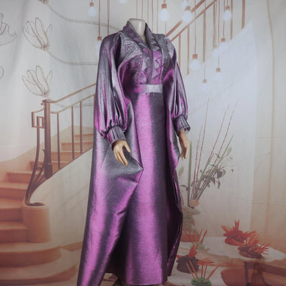 Full-length model shot of a woman wearing a luxury elegant V-neck turkey dress with a traditional African boubou style, ideal for festive occasions.