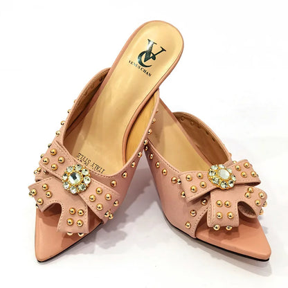 Elegant view of luxurious high heeled pumps with thin heels and distinctive rivet embellishments for refined style.