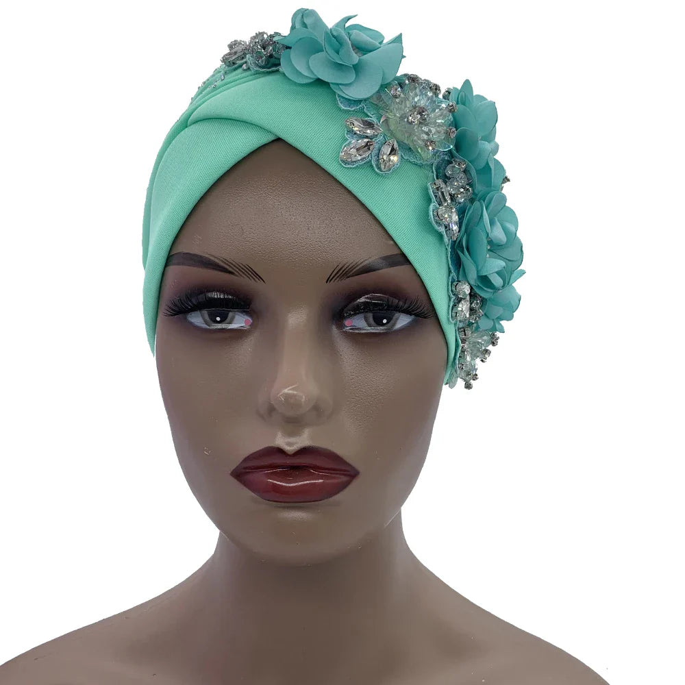 Close-up view of an exquisite rhinestone detail on an African turban cap, showcasing its luxurious design and craftsmanship.