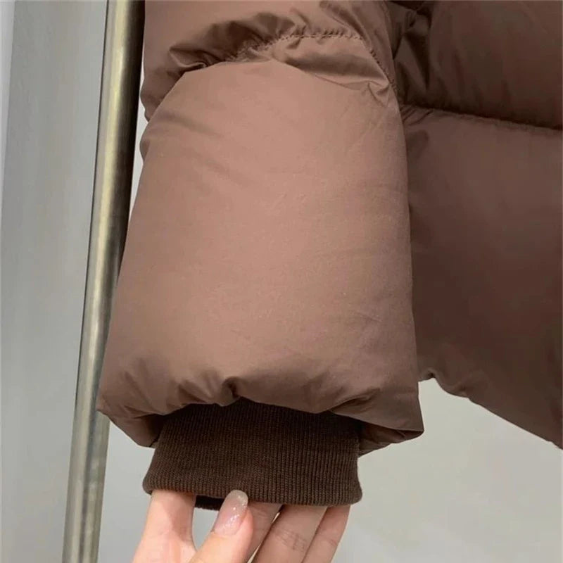 Luxurious cropped down coat for women, featuring a stylish hood and elegant solid design, perfect for casual winter streetwear.