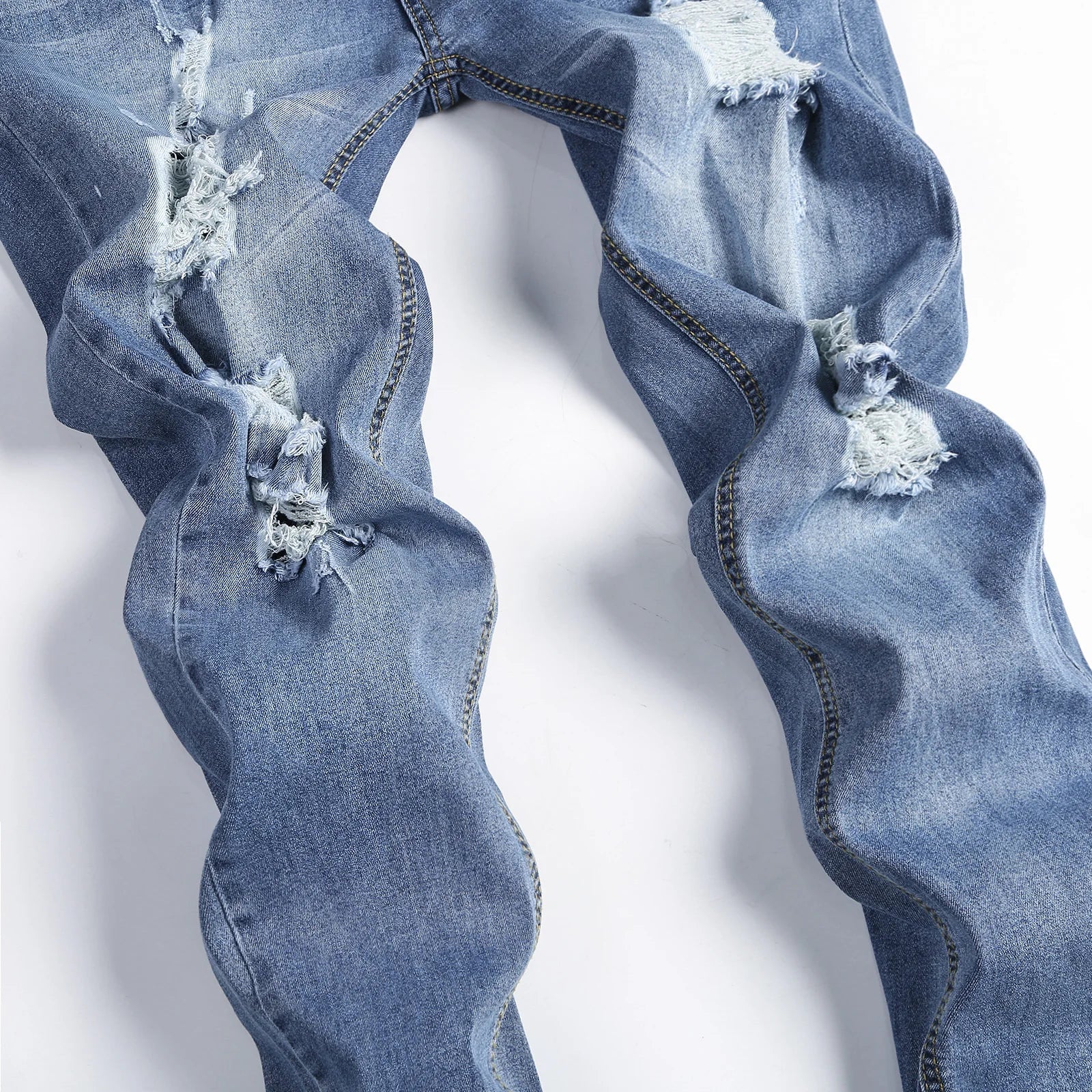 Close-up of Luxury Men's Ripped Skinny Jeans, detailing the high-quality denim and trendy design elements.